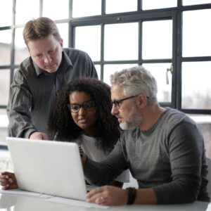 3 people looking at a computer